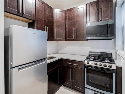 a kitchen with stainless steel appliances and wooden cabinets
